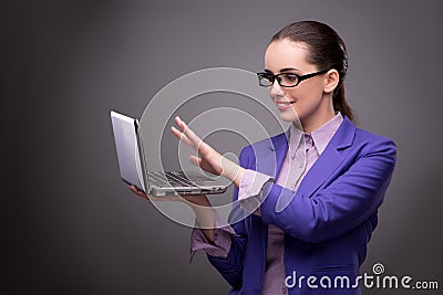 The young businesswoman working with laptop in business concept Stock Photo