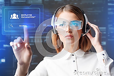 Young businesswoman working in virtual glasses, select the icon employee engagement on the virtual display Stock Photo