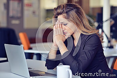 Young busy beautiful latin business woman suffering stress working at office computer Stock Photo