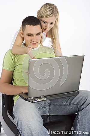 Young busy couple with laptop Stock Photo