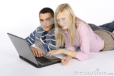 Young busy couple with laptop Stock Photo