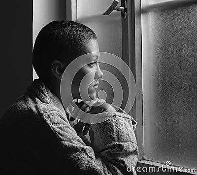 Young cancer patient in front of hospital window Stock Photo