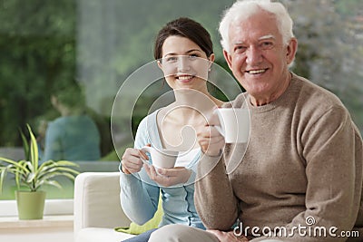 Young caregiver and elderly male Stock Photo