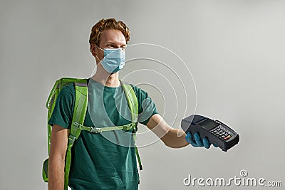 Young carrier man showing bank terminal Stock Photo