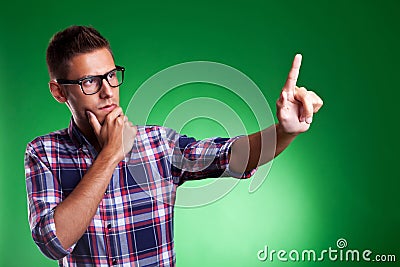 Young casual man pensively selecting something Stock Photo
