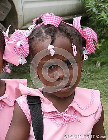 Young Catholic kindergarten school girl poses for camera in rural village. Editorial Stock Photo
