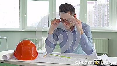 Architect takes off his glasses Stock Photo