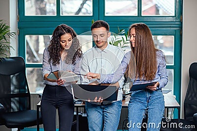 Young caucasian architects or designers using color palette for new project on the laptop in the stylish modern office Stock Photo