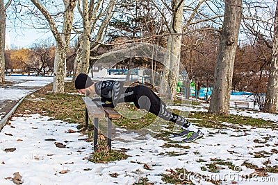 Youn caucasian man training in winter park Stock Photo