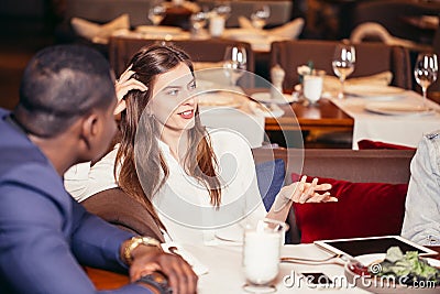 Group of young people meeting in restaurant at dinner Stock Photo