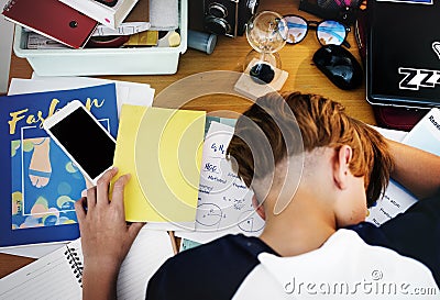 Young caucasian boy fell a sleep while doing homework Stock Photo