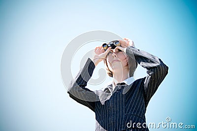 Young caucasian business lady with binoculars Stock Photo