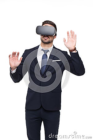 Young caucasian businessman in VR glasses touching imaginary but Stock Photo