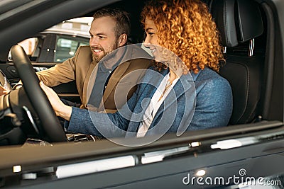 Young caucasian family came to buy new car Stock Photo