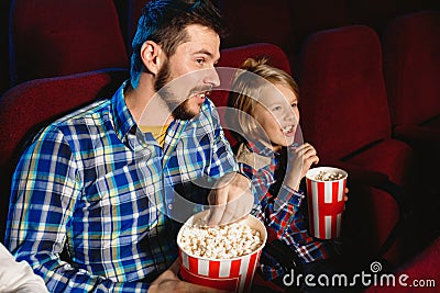 Young caucasian father and son watching a film at a movie theater Stock Photo