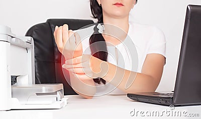 Young caucasian girl office worker holds on wrist joint pain and inflammation concept in hand, tunnel syndrome Stock Photo