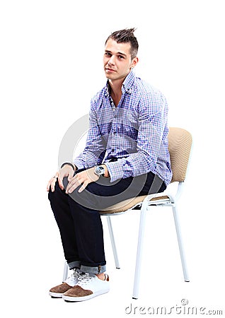 Young caucasian handsome man sitting on the chair Stock Photo