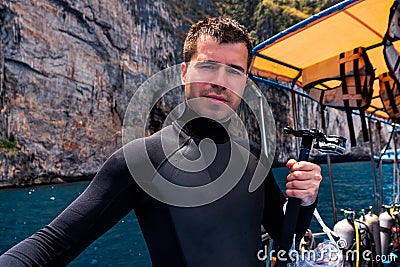 Male scuba diver holding action camera and preparing for diving, Phi Phi Island Stock Photo