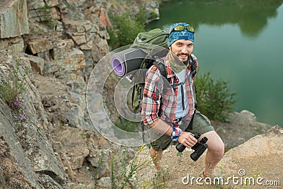 Young caucasian man with backpack climbing the Stock Photo
