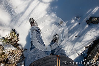 MAN`S LEGS WEARING JEANS PANTS AND MOUNTAIN BOOTS Stock Photo