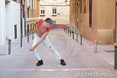 Young caucasian man with long false nails dancing at street, contemporary dance. Stock Photo