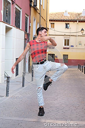 Young caucasian man with long false nails dancing at street, contemporary dance. Stock Photo