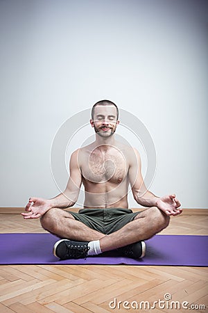 Casual yoga meditation on a yoga mat Stock Photo