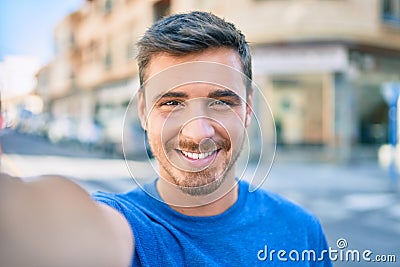 Young caucasian man smiling happy making selfie by the camera at the city Stock Photo