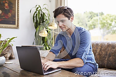 Young Caucasian man using laptop in a coffee shop Stock Photo