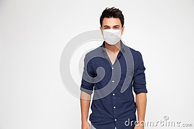 Young caucasian man wearing face mask and looking at camera isolated on white background Stock Photo