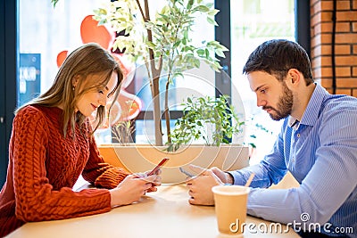 Young man and woman in cafe, using tablet Stock Photo