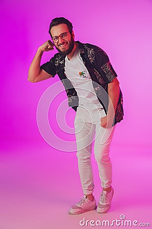 Young caucasian musician, dancer, partyhost in neon light Stock Photo