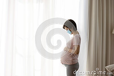 Caucasian pregnant woman in facemask against infection Stock Photo