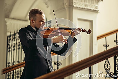 Young caucasian talented violinist play violin Stock Photo