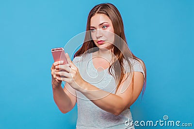 Young caucasian woman read the phone message with incredulous grimace Stock Photo