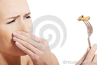 Young caucasian woman eating seafood with disguise. Stock Photo