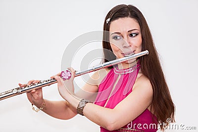Young Caucasian woman flutist playing on flute, Stock Photo