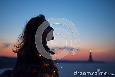 Young caucasian woman with lighthouse Stock Photo