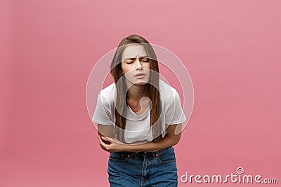 Young caucasian woman over isolated background with hand on stomach because indigestion, painful illness feeling unwell Stock Photo