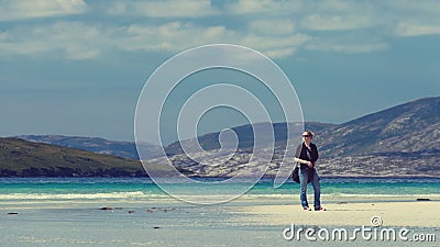 Young Caucassian woman enjoying holiday on a white sandy beach with turquoise water Stock Photo