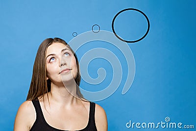 Young causacian woman with blue eyes up thinks or dreams about something. Stock Photo