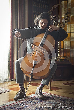 Young cellist playing cello seriously Stock Photo