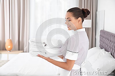 Young chambermaid with clean towels Stock Photo