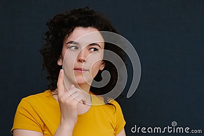 Young charismatic caucasian woman showing finger up on the grey background. Stock Photo
