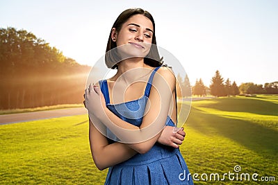 Young charming woman on green lawn. Stock Photo