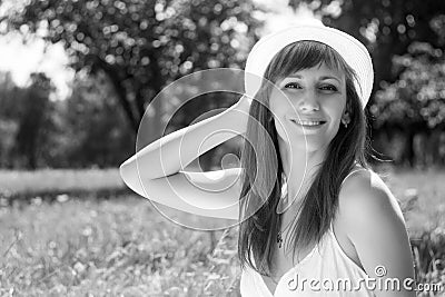 Young cheerful adult girl in summer park Stock Photo