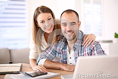 Young cheerful couple calculating budget Stock Photo