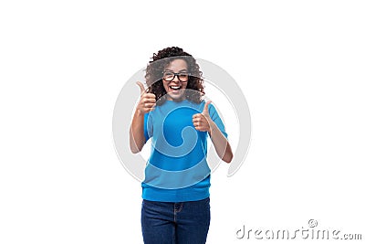 young cheerful curly woman with black hair dressed in a blue corporate t-shirt with print mockup Stock Photo