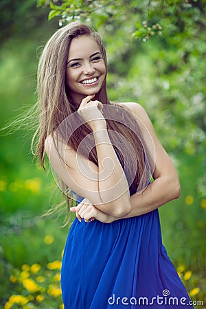 Young cheerful and happy girl posing in spring park Stock Photo