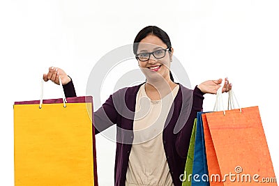 Young cheerful woman holding shopping bags Stock Photo